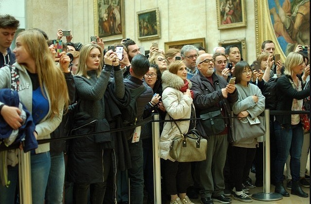 In Paris, the Louvre Museum displays a full house and represses tourists